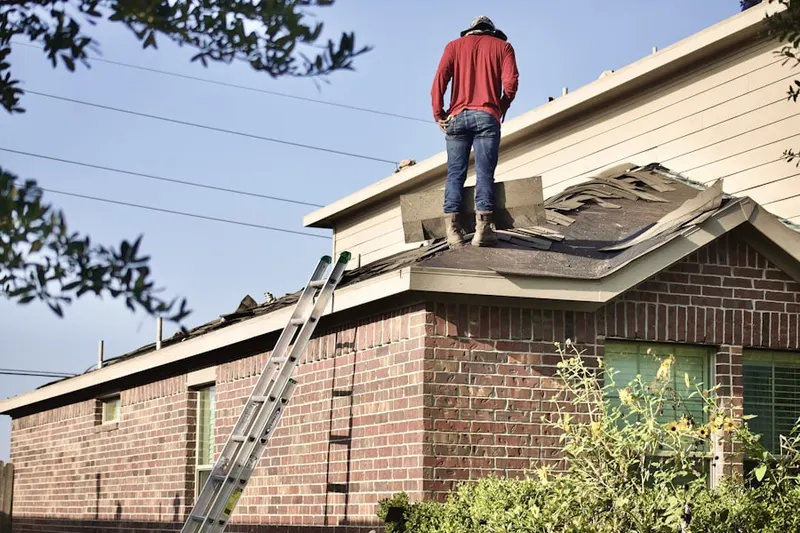 Professional roofer working on a residential roof in Zimmerman